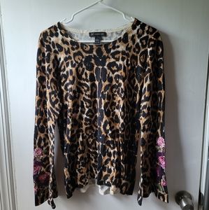 Animal print blouse with floral detail.